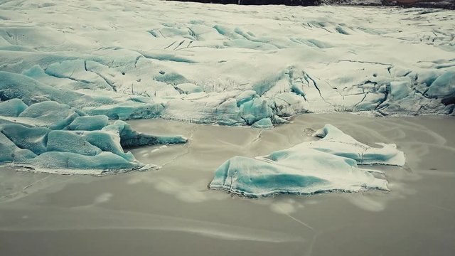Glacier tongue in Iceland filmed by drone with different cinematic movements, showing a cloudy, dramatic concept in wintery conditions. Shot with DJI Mavic Pro