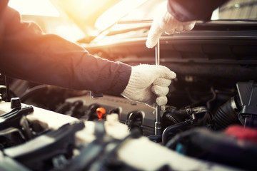 The car mechanic in the center is working. Choose the focus.