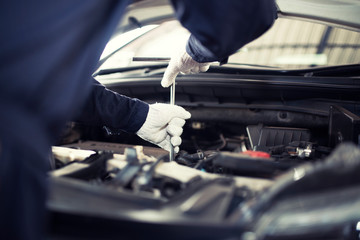 The car mechanic in the center is working. Choose the focus.