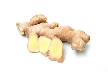 fresh ginger root closeup view, Thick tuberous vegetable with brown skin and pale yellow flesh on white background