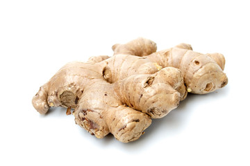 fresh ginger root closeup view, Thick tuberous vegetable with brown skin and pale yellow flesh on white background