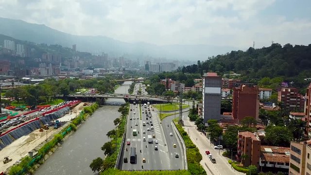 Dramatic ascending 4k aerial shot of roads intersection and big traffic in Medellin