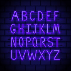 Neon style letters, glowing in night latin alphabet on a brick wall. Luminous uppercase font for neon signs and billboards decoration. Vector