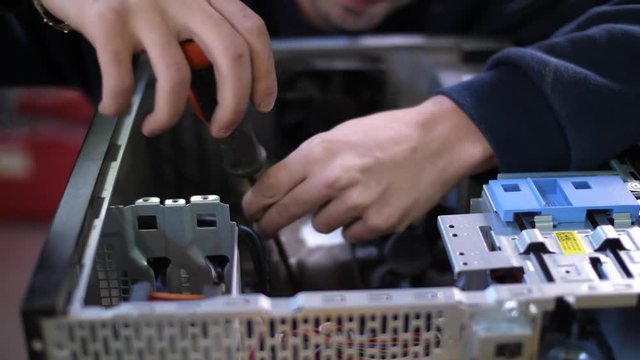 Man preparing computer for recycling unscrewing parts of hardware. Close up shot