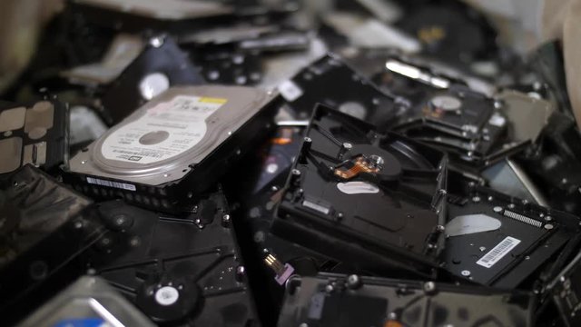 Dolly shot of pile of computer hard drives designed for recycle