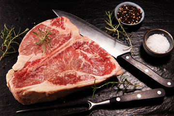 Fototapeta na wymiar Raw T-bone steak on stone cutting board.