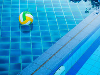 Volleyball ball floats in the blue pool