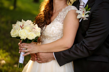 Happy beautiful wedding cuple posing in park