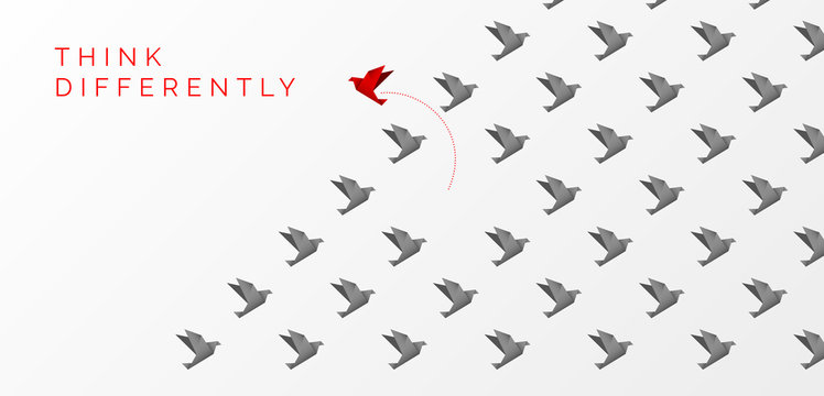 Think differently concept. Origami bird changing direction