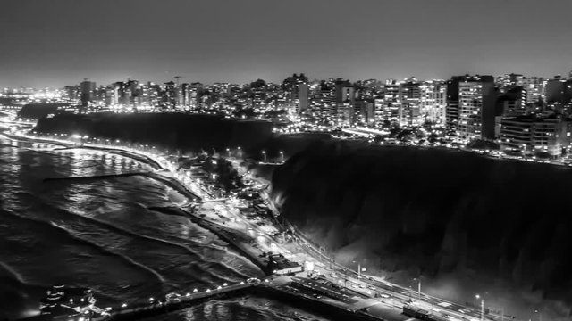 Aerial night shots with drone, hyperlapse in black & white on the Costa Verde in Miraflores Lima Peru in 4K