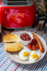 Traditional English Breakfast - Eggs, Sausage, Tomato, Toasts, Beans