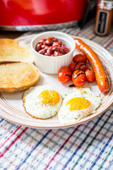 Traditional English Breakfast - Eggs, Sausage, Tomato, Toasts, Beans