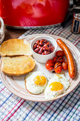 Traditional English Breakfast - Eggs, Sausage, Tomato, Toasts, Beans