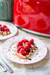 Homemade Toasts with Goat Cheese, Raspberries, Balsamic Cream and Pine Nuts