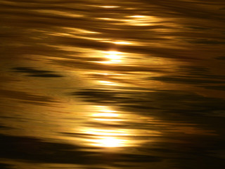 Abstract gold water wave reflection with sunrise