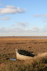 Fototapeta na wymiar Old wreck of a fishing boat on the coast at Blakeney Norfolk UK