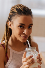 Woman drinking protein shake after exercising at home