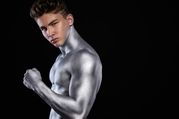 Fototapeta premium Brutal strong muscular bodybuilder athletic man pumping up muscles on black background. Workout bodybuilding concept. Copy space for sport nutrition ads.