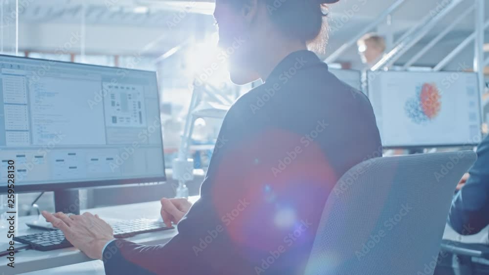 Fototapete Back View of Team of Technology Engineers Working on Desktop Computers in Bright Office. Screens Show IDE / CAD Software, Implementation of Machine Learning, Neural Networking and Cloud Computing