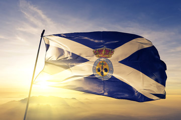 Santa Cruz de Tenerife province of Spain flag waving on the top sunrise mist fog