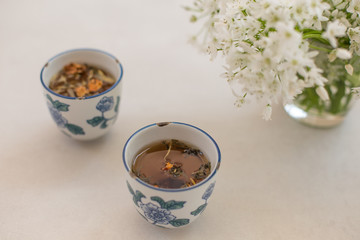 Herbal tea in Asian style ceramic cups