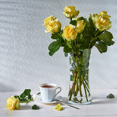 Still life with a bouquet of roses and a Cup of tea