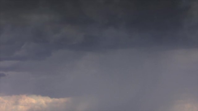 Cinematic storm clouds with lightning strikes reflecting 