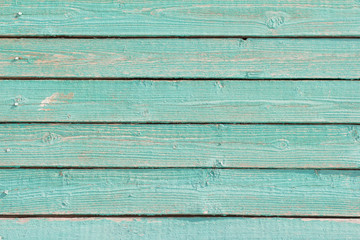 wooden background, old wooden wall, painted in turquoise color, with slits and nails