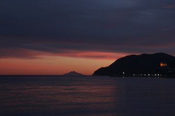Sunset over Marina di Campo bay and Montecristo island, Elba island, Tuscany, Italy