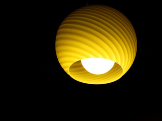 yellow lamp on black background