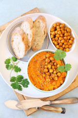 Vegetarian appetizer. Carrot and hummus dip and bread, sesame and chick-pea dressing