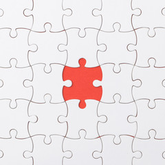 Fototapeta premium unfinished jigsaw puzzle texture on red background. connection concept. idea concept.association concept