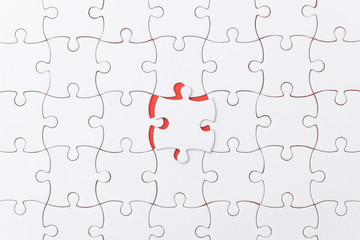 unfinished jigsaw puzzle texture on red background. connection concept. idea concept.association concept