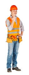 Portrait of a male builder in a helmet  looking at camera over white wall background. repair, construction, building, people and maintenance concept.