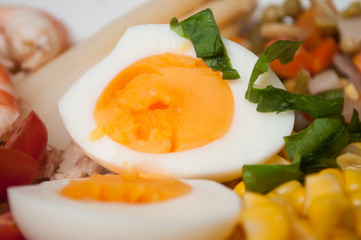 closeup of hard boiled eggs with vegetables in a plate