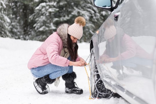 girl driver using car winter chains