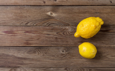 Two trendy ugly organic lemons on a wooden background. Horizontal orientation of the image. Copy space