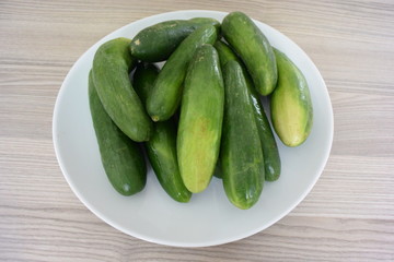 Fresh organic cucumbers on plate