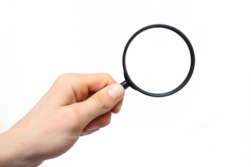 Man's hand with magnifying glass.