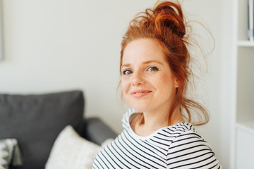 Smiling friendly young redhead woman