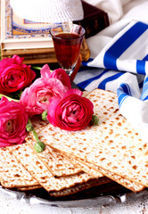 Matzo and prayer sahwl in front of ranunculus 