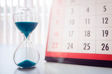 Hour glass and calendar important appointment date, schedule and deadline - obrazy, fototapety, plakaty