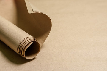 Kraft paper roll on kraft paper background. Eco paper. Recyclable, ecological. Place for text