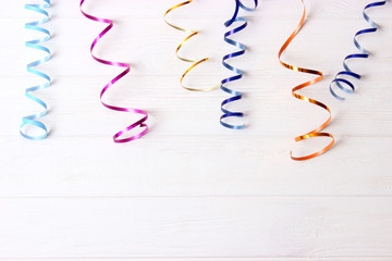  Festive background of ribbons and confetti on a colored background top view.