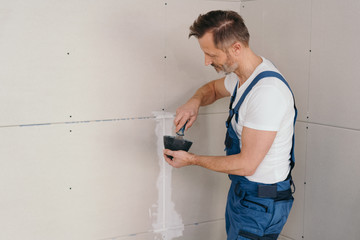 Builder grouting and sealing wall cladding