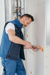 Handyman or electrician installing plug points