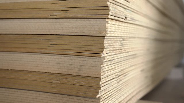 Elements from thin hdf board stacked on pallets in the carpentry warehouse