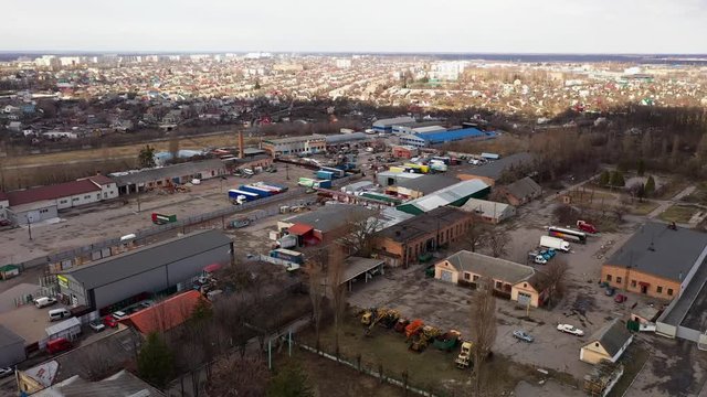 Aerial of an industrial complex with a Ukrainian city in the background.