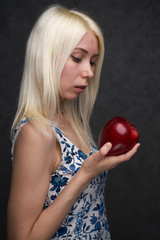 beautiful girl in a fashionable dress with apple