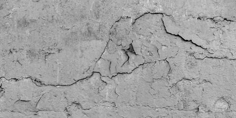 Old cracked paint on the concrete wall. Peeling paint on wall texture. Pattern of rustic blue grunge material